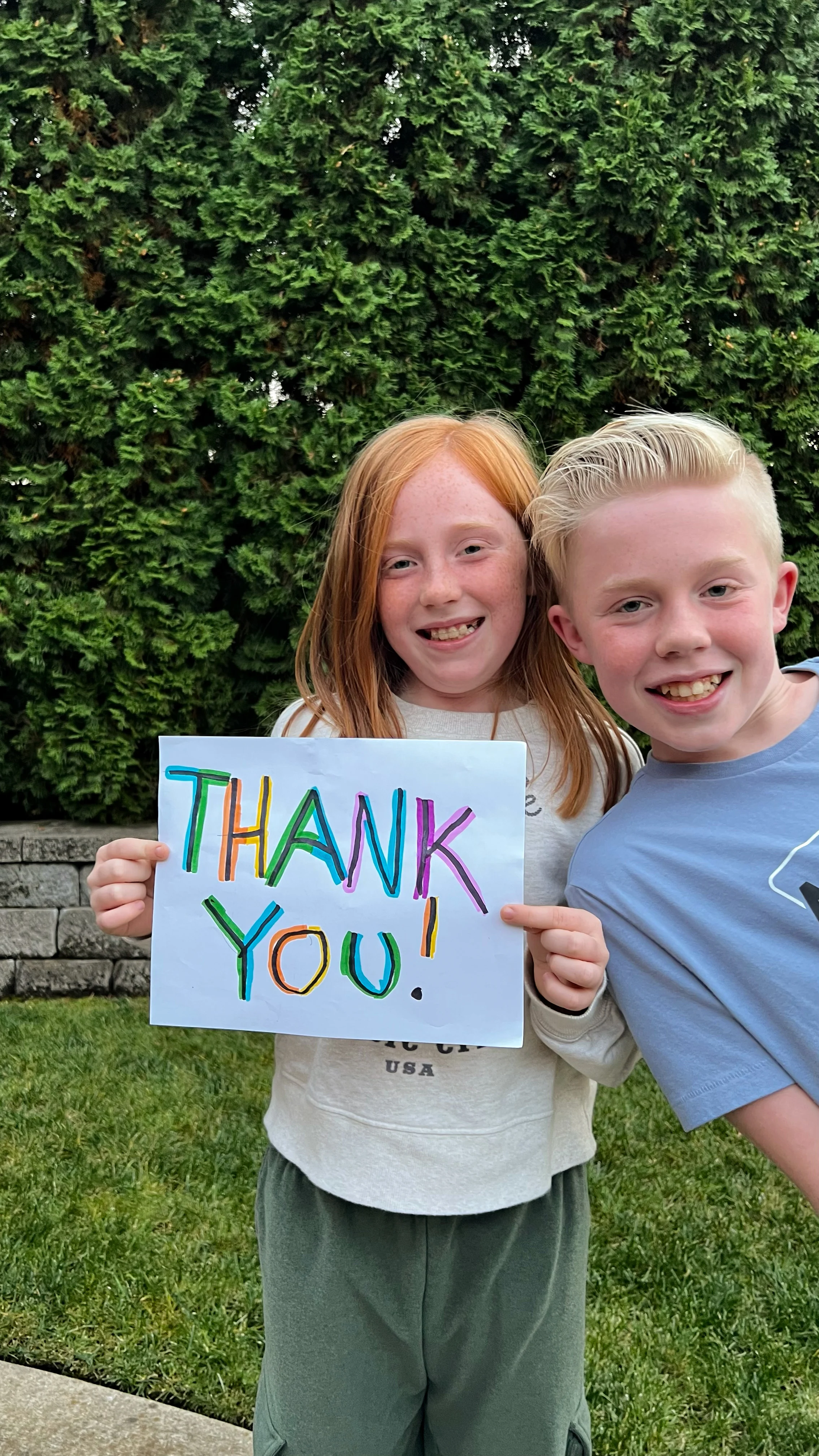 Children holding thank you sign